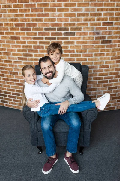 Kids hugging father — Stock Photo