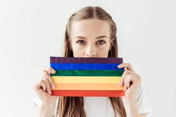 Woman covering mouth with rainbow flag — Stock Photo