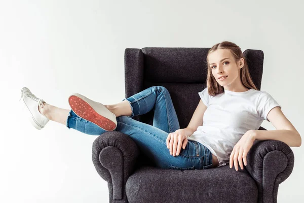 Girl on armchair — Stock Photo