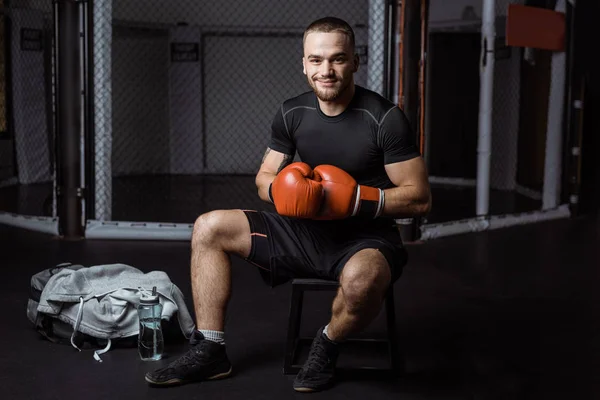 Muscular sportsman in boxing gloves — Stock Photo