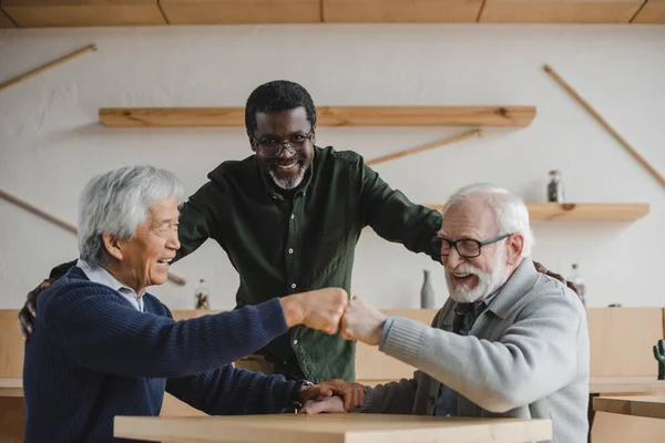 Senior friends making bro fist — Stock Photo