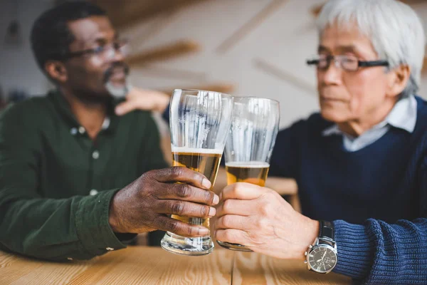 Senior friends clinking glasses — Stock Photo