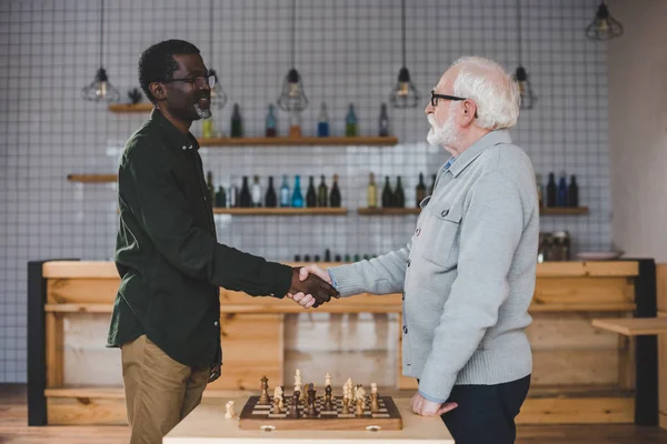 Senior men playing chess — Stock Photo