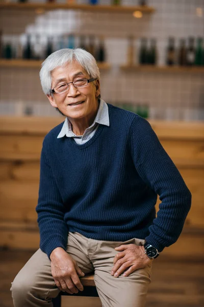 Senior asian man in bar — Stock Photo