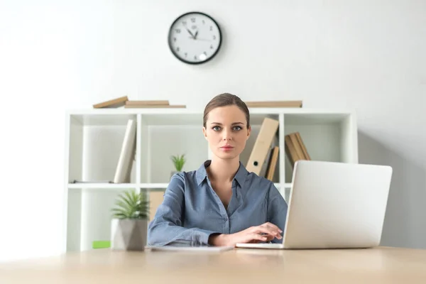 Serious businesswoman with laptop — Stock Photo
