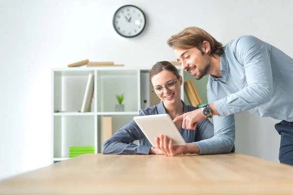 Businessman showing something on tablet — Stock Photo