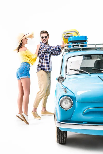 Couple putting luggage on car roof — Stock Photo