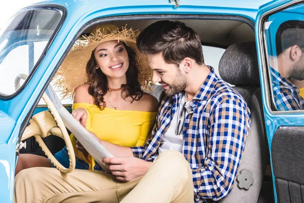 Couple with map in car — Stock Photo