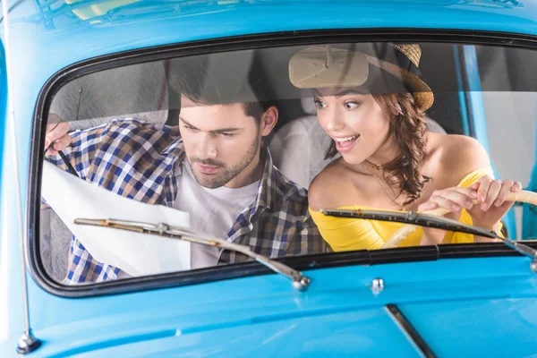 Travelers with map in car — Stock Photo