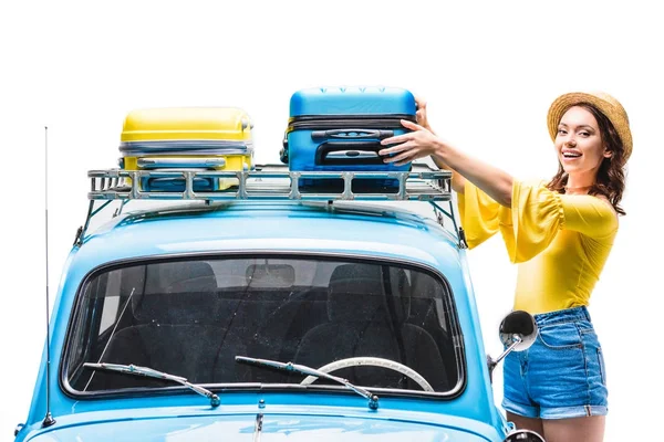Woman putting luggage on car roof — Stock Photo