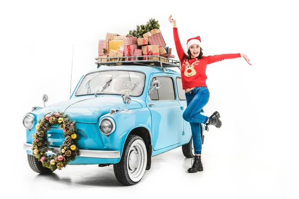 Woman with christmas gifts on car roof — Stock Photo
