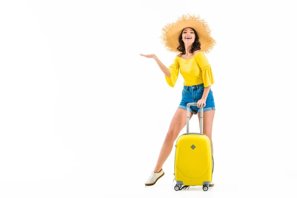 Woman with luggage showing something with hand — Stock Photo