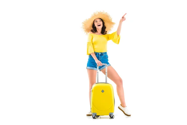 Woman with luggage pointing up — Stock Photo