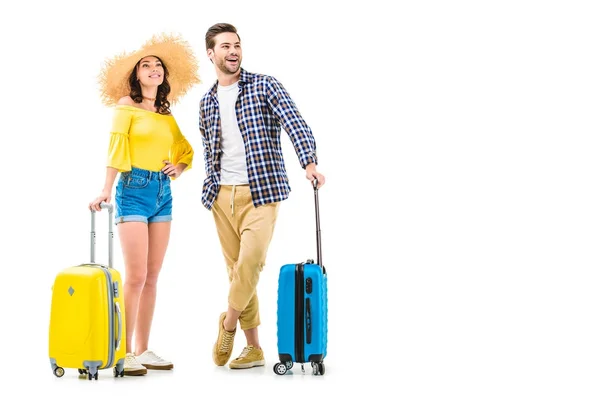 Couple of tourists holding luggages — Stock Photo