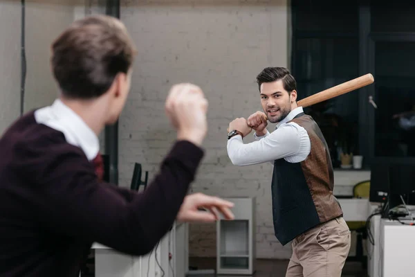 Young businessmen playing baseball in officebaseball bat — Stock Photo