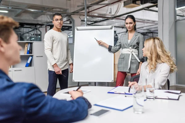 Group of young multiethnic managers making presentation for boss in modern loft office — Stock Photo