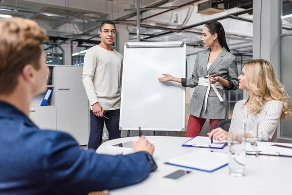 Group of multiethnic managers making presentation for boss at conference hall — Stock Photo