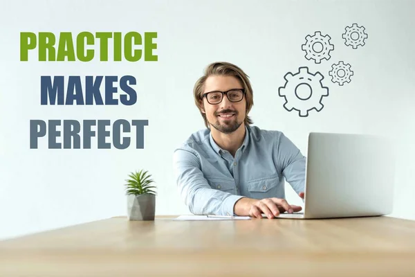 Smiling businessman working at laptop in office with practice makes perfect inscription and cogs icons — Stock Photo