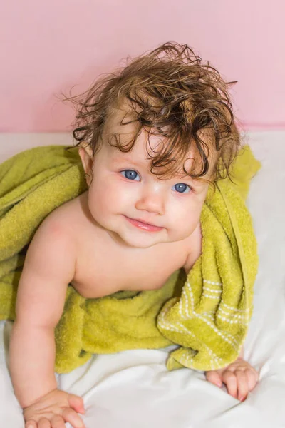 Little baby in a green towel after bathing. — Stock Photo, Image