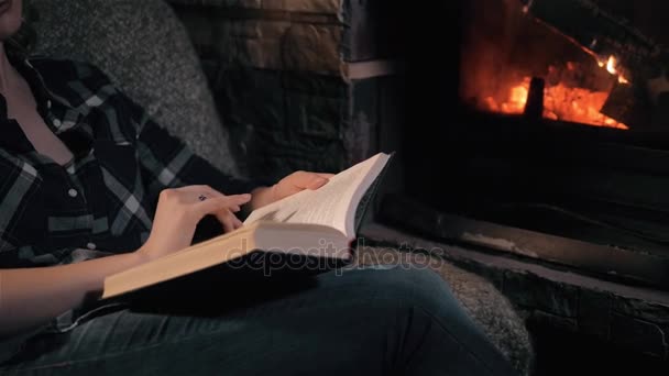 Beautiful Young Woman Reading Book Sitting By Fireplace In a Country House. Close Up SHot, Holiday And Lifestyle Concept — Stock Video