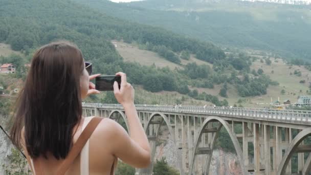 Chica Turista Tomando Foto Por Teléfono Del Puente Djurdjevic En Montenegro, Viajar Estilo De Vida — Vídeos de Stock