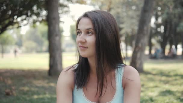 Portrait of Pretty Young Woman Sitting On Lawn In Park In Sunny Summer Day — Stock Video