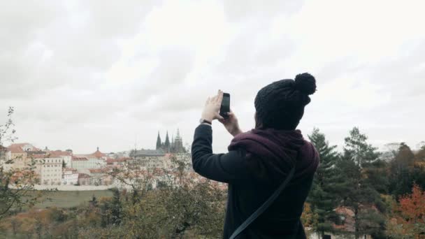 Красивая молодая женщина турист в Праге, делать селфи или фотографироваться с мобильного телефона, Путешествие концепции — стоковое видео