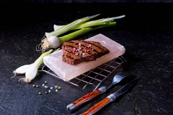 Steak on hot salt stone — Stock Photo, Image