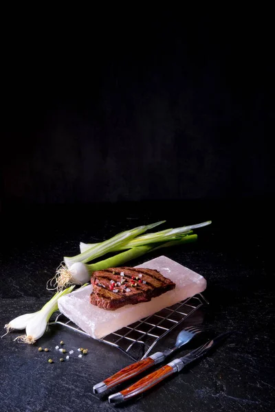 Steak on hot salt stone — Stock Photo, Image