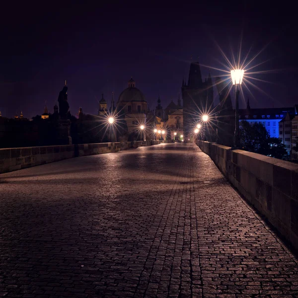 Charles bridge and illuminated buildings — Stock Photo, Image