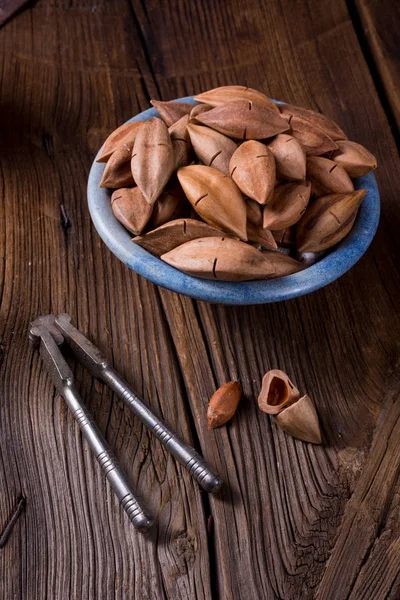 Pili nuts  in blue bowl — Stock Photo, Image