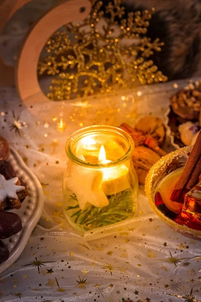 Glass jar with candle and Christmas decoration — Stock Photo, Image
