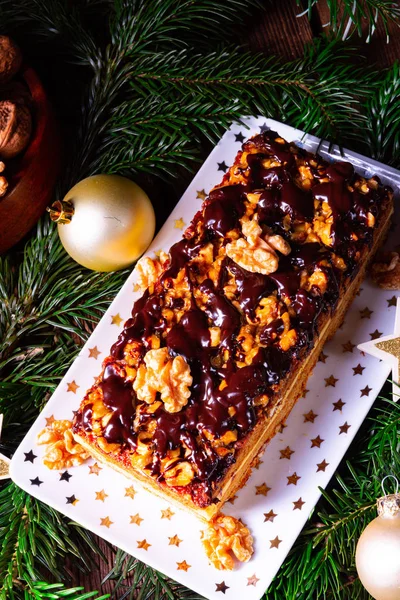 Chocolate gingerbread with filling, jam and nuts — Stock Photo, Image