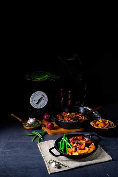 Rib of pork with beans and quarter potato — Stock Photo, Image