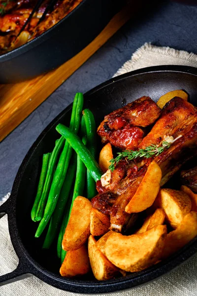 Rib of pork with beans and quarter potato — Stock Photo, Image