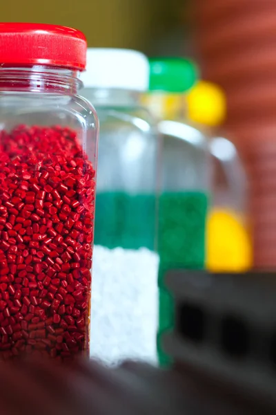 Multicolored granules in cans — Stock Photo, Image