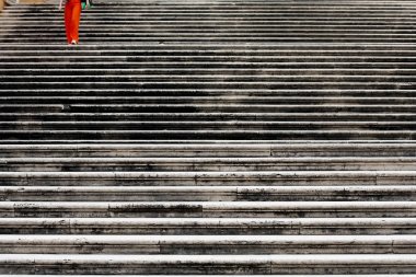 A woman descends the long stairs in Rome clipart