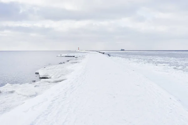 Une jetée au phare à l'embouchure en hiver — Photo