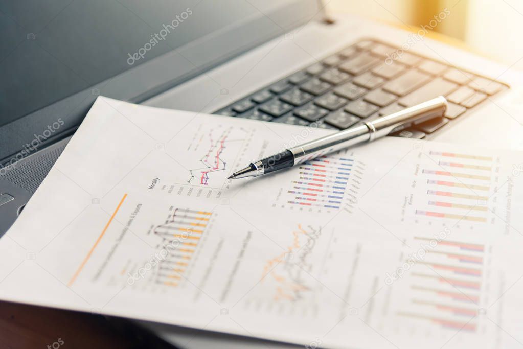Financial documents on laptop