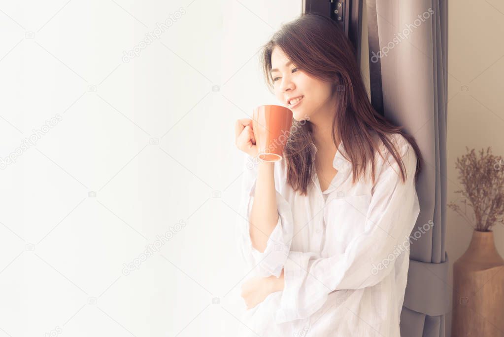 Asian woman drinking coffee in morning