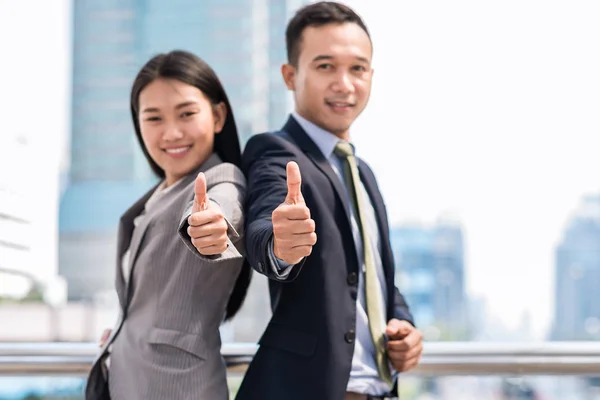 business Asian man and woman gesturing thumb up