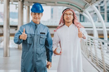 Mühendis ile Arap işadamı başparmak sırıtmak