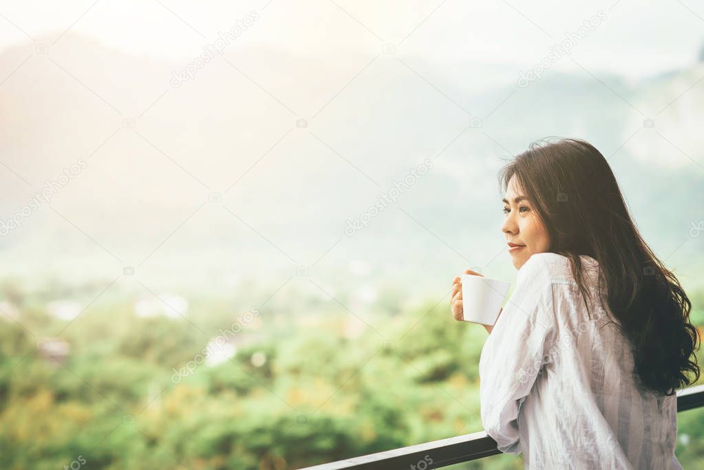 Asian woman drinking a cup of coffee