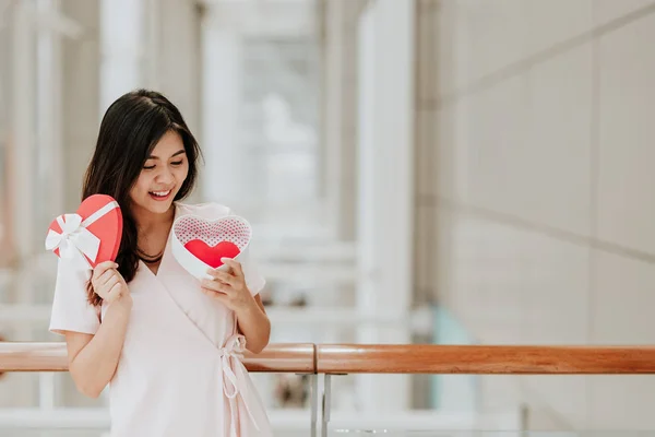 Mosolygós ázsiai nő kezében ajándék doboz piros szív Valentin — Stock Fotó