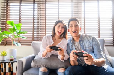 Couple having a good time playing video game together