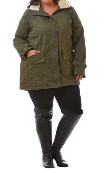 Portrait of plus size model woman wearing XXL dark green winter coat and black leggins posing isolated on white background. — Stock Photo, Image