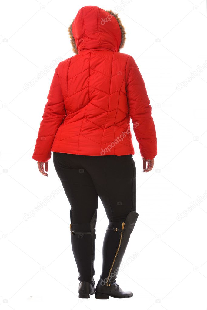 portrait of plus size model woman wearing XXL red warm winter coat and black leggins posing isolated on white background