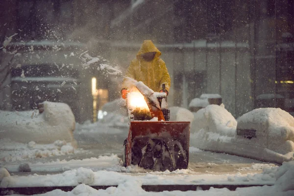 Mann mit Schneefräsmaschine bei der Arbeit und Reinigung der Straße im Winter bei Schneesturm in New York City — Stockfoto