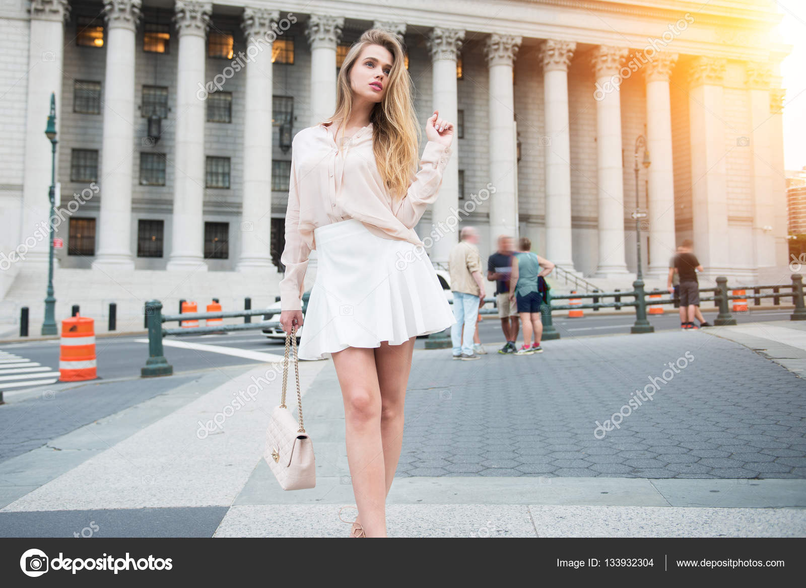 Fashionable city girl concept. Gorgeous young woman walking near
