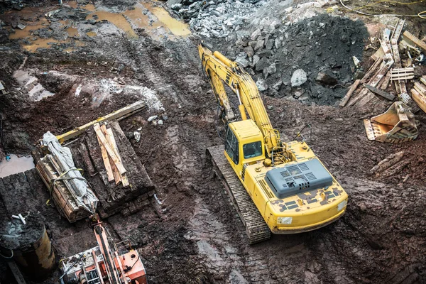 Escavadora amarela escavando no canteiro de obras . — Fotografia de Stock